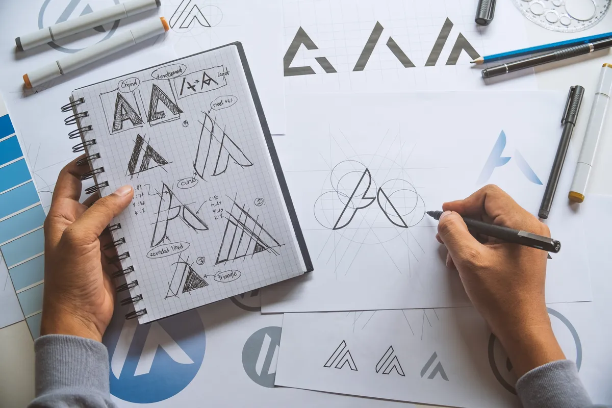 Designer sketching logo concepts during the creative development process