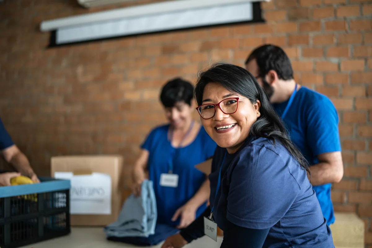 Nonprofit team collaborating at a community outreach event with volunteers